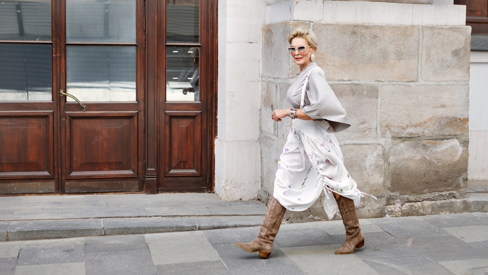 fashionable,mature,woman,walking,city,wearing,asymmetrical,gray,loose fit,blouse,