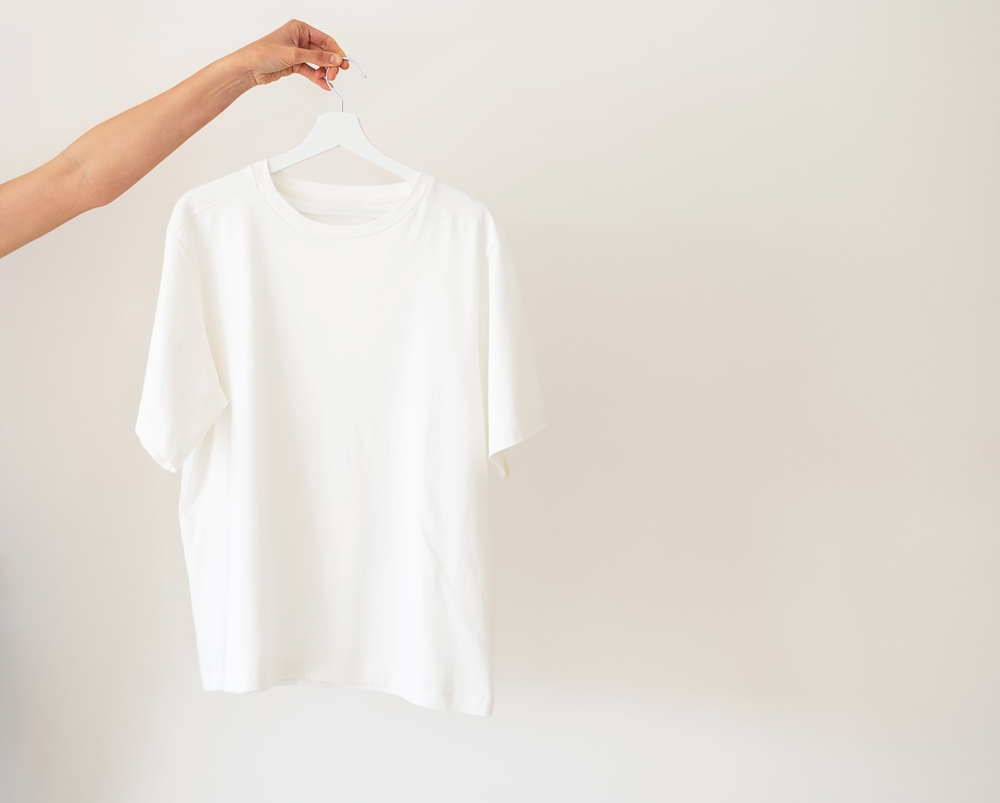 white,women's,jersey.,a,woman,holds,a,white,t shirt,with